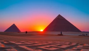 Pyraminds towering against a vibrant sunset, highlighting their ancient majesty and complexity.